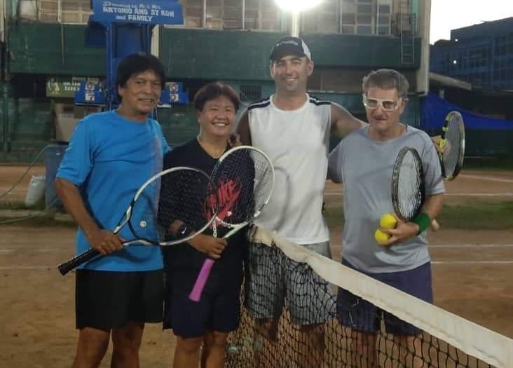 Playing Tennis in Dumaguete at Praxevilla Tennis Club with friends.