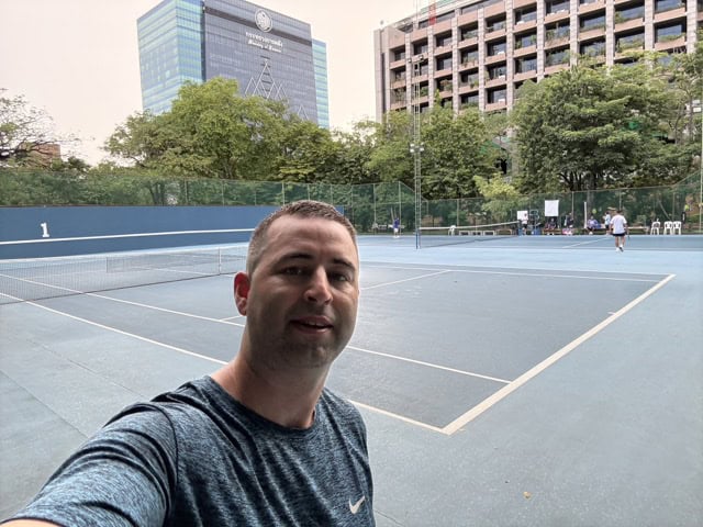American tourist selfie at Public Relations Department tennis court in Bangkok, Thailand near Ari BTS station.