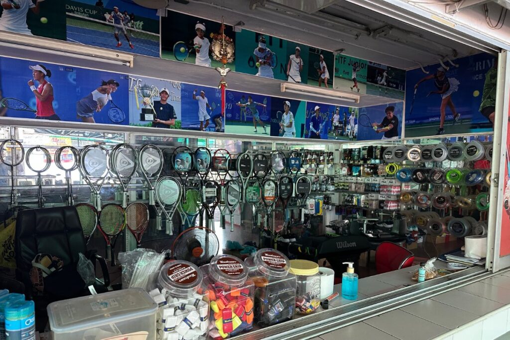 The tennis shop store at 700-year stadium in Chiang Mai, Thailand. Picture shows tennis equipment, racquets, shoes, strings, etc. for sale.