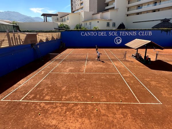 Red clay courts at Canto del Sol Tennis Club in Puerto Vallarta, Mexico.