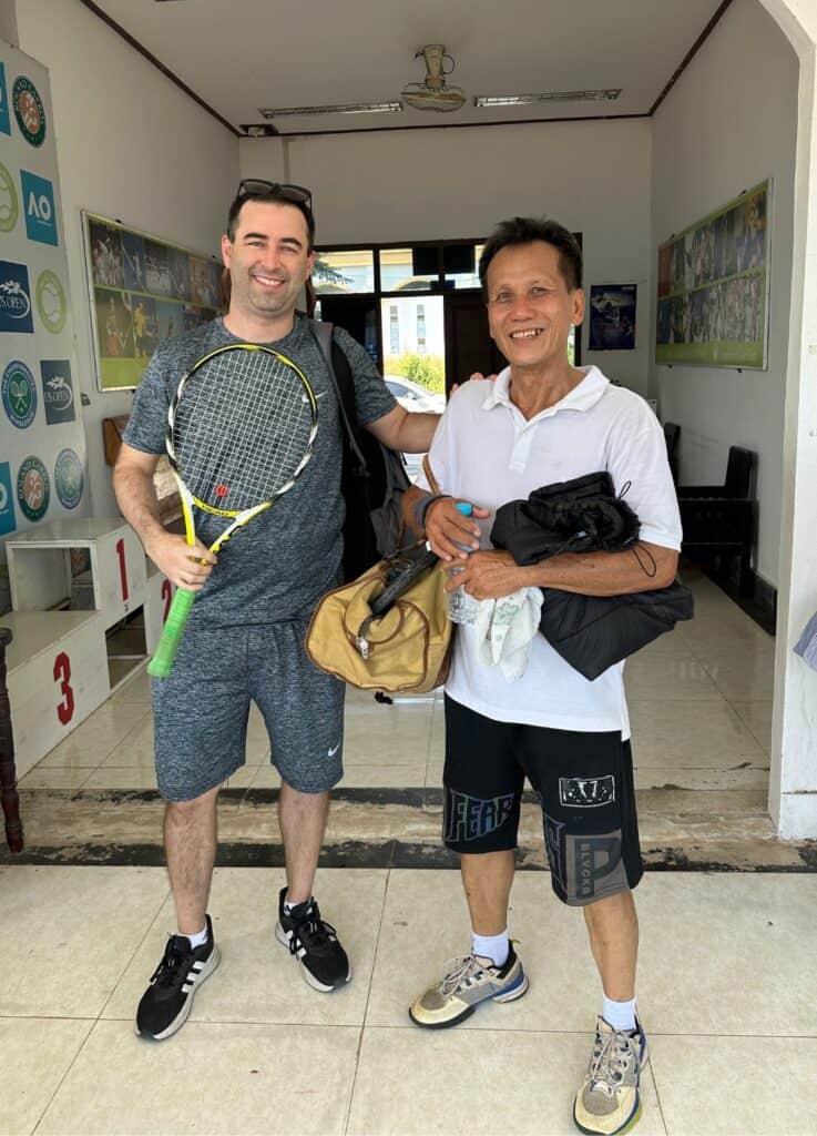 Lao tennis player and American tennis player in Luang Prabang Tennis Club in Laos.