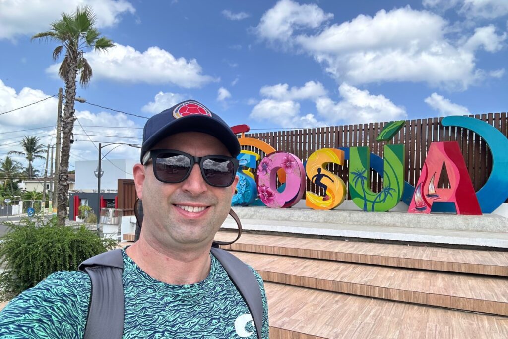 American tourist selfie at Sosua town sign in Dominican Republic.