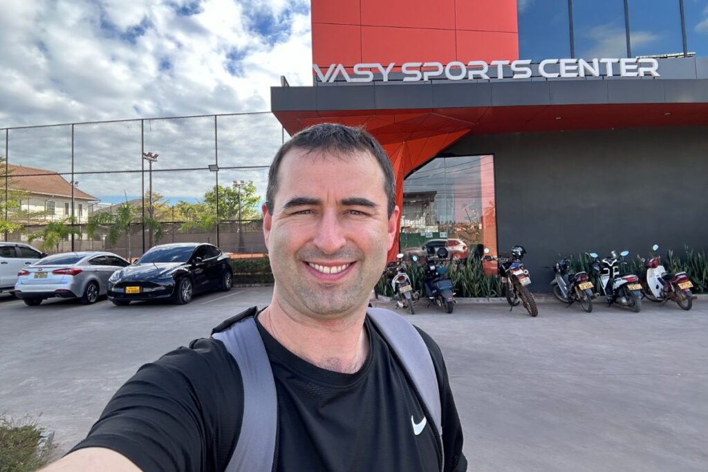 Vasy Sports Center parking lot and entrance sign selfie by American visitor Eric Claggett.