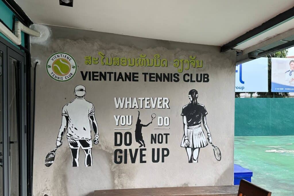 Vientiane Tennis Club cool sign, "Whatever you do, do not give up." in Vientiane, laos.