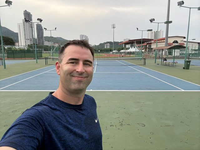Eric Claggett with Primal tennis selfie at USM tennis courts in Georgetown, Penang, Malaysia,